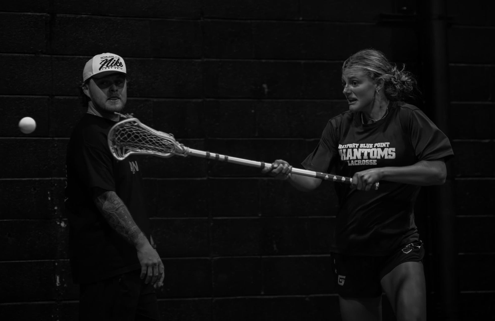 Coach McGinn working with a player on the wall