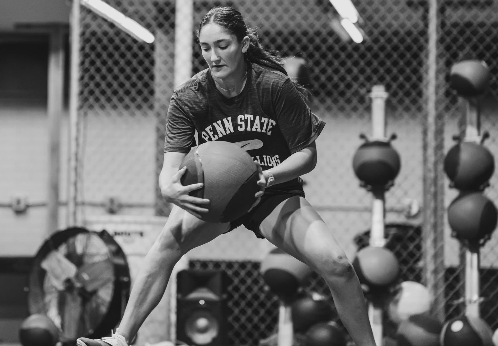 Player doing med ball work in the cage